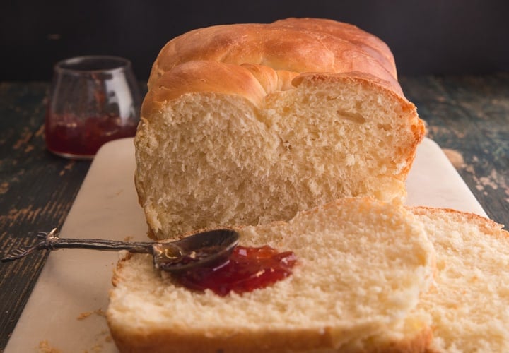 brioche bread with 2 slices and jam and a spoon