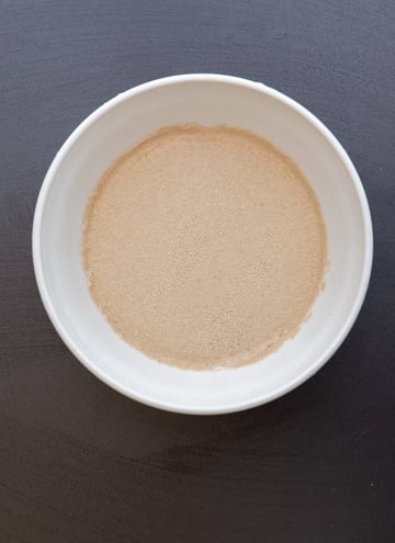 yeast and water in a white bowl