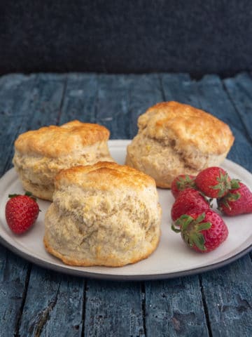 scones on a plate with strawberries.
