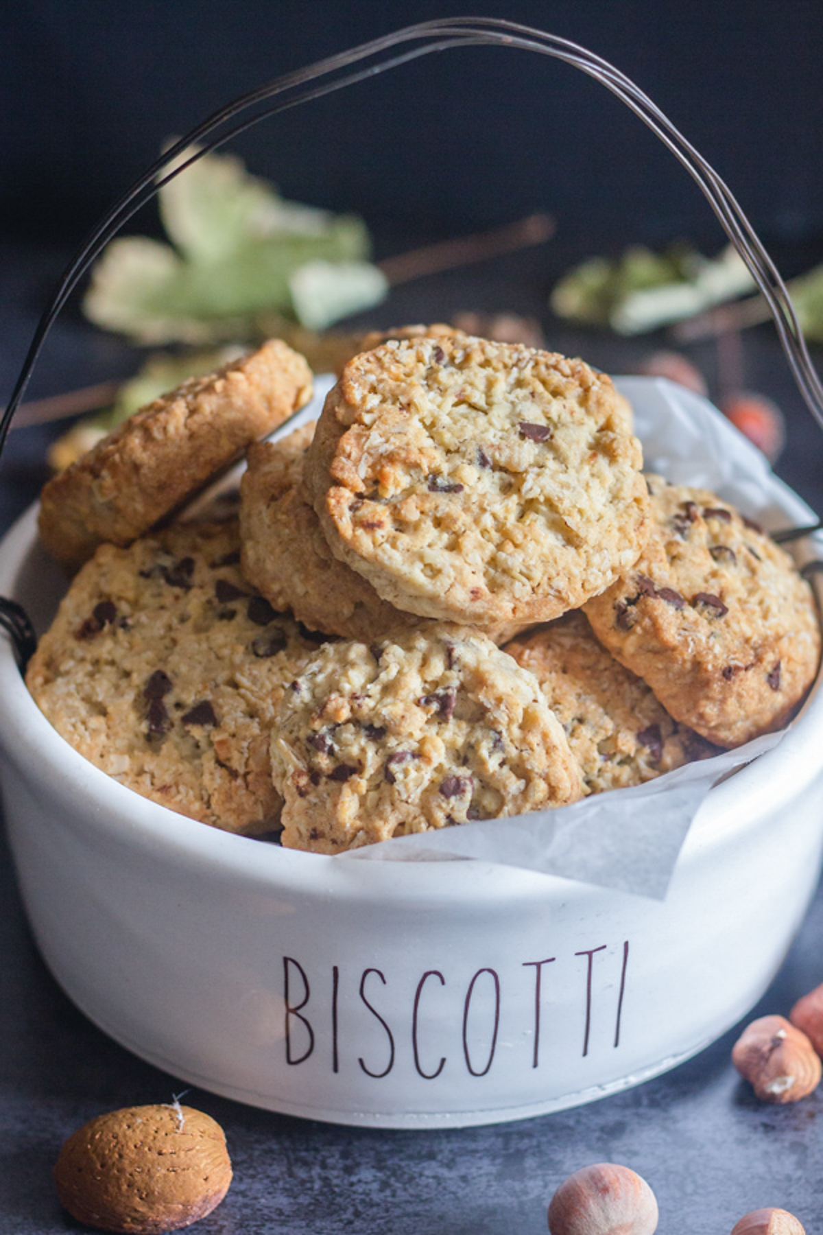 Oatmeal cookies in a white biscotti bowl.