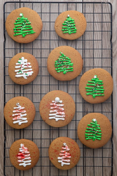 Decorated cooled gingerbread cookies on a wire rack.